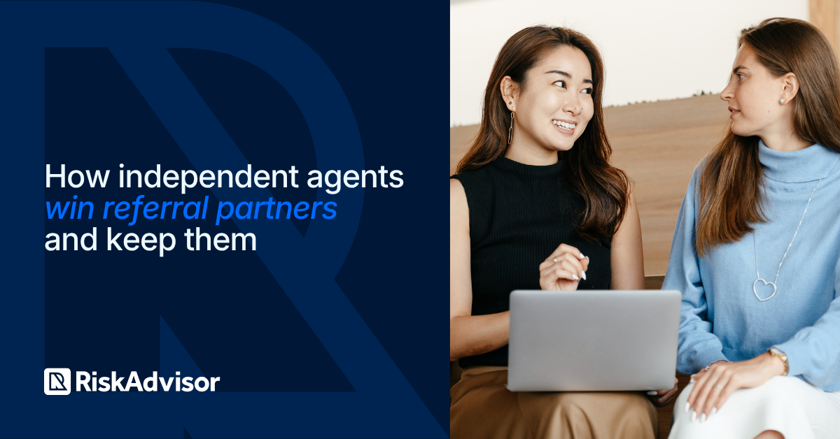 Independent insurance agent showing a referral partner a co-branded quote form on a laptop during a meeting